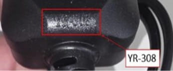 Close-up photograph of a UK plug showing the YR-308 marking highlighted with a red box and arrow